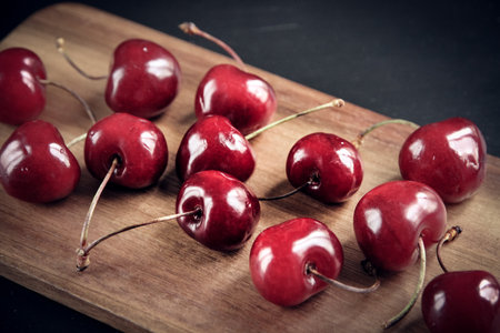 Organic fresh cherries on a wooden cutting board