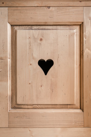 Rustic cupboard door with an engraved heartの写真素材