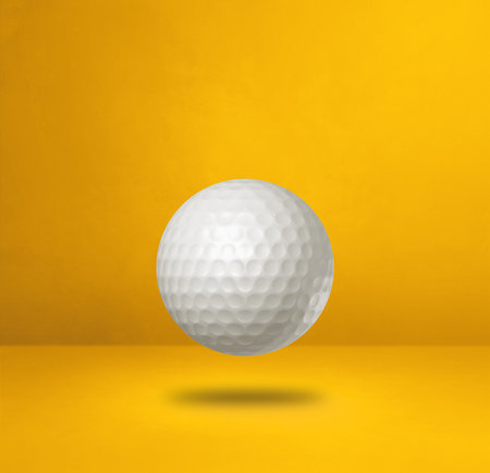White golf ball isolated on a yellow studio background. 3D illustrationの写真素材