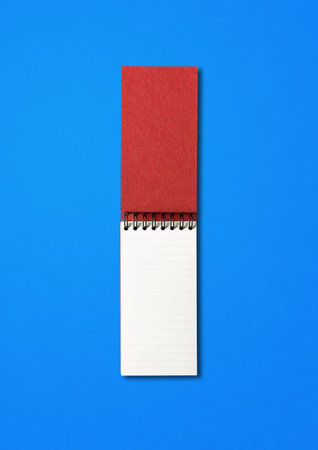 Blank open spiral notebook mockup isolated on blue