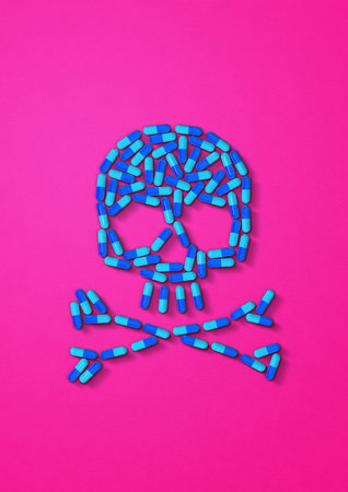 Skull made of blue capsule pills isolated on pink background. 3D illustration