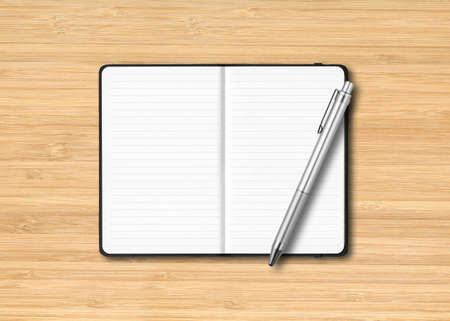 Black open lined notebook mockup with a pen isolated on wooden backgroundの写真素材