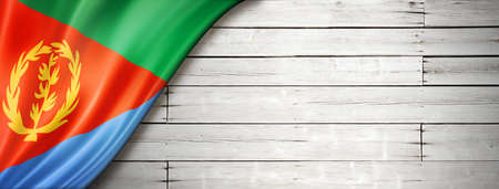 Eritrea flag on old white wall. Horizontal panoramic banner.の写真素材