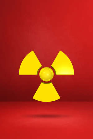 Radioactive symbol isolated on a red studio background. 3D illustrationの写真素材