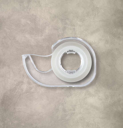 Transparent dispenser isolated on concrete background