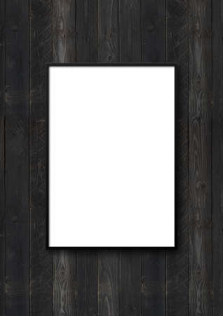 Black picture frame hanging on a black wooden wall. Blank mockup template