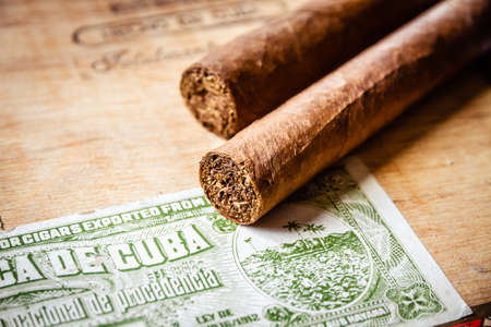 Cigars on vintage wooden box with Cuban official tax labelの写真素材
