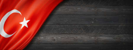 Turkey flag on black wood wall. Horizontal panoramic banner.の写真素材
