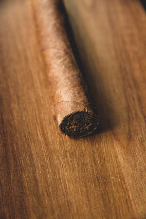 Brown cuban cigar on old wooden backgroundの写真素材
