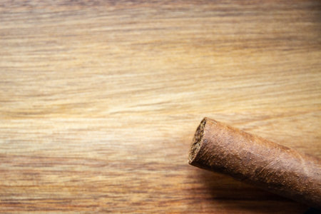 Brown cuban cigar on old wooden backgroundの写真素材
