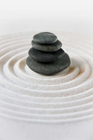 Black stones pile in the sand. Zen japanese garden background scene