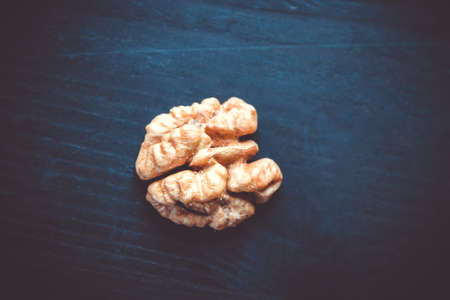 Walnut kernel on a black wooden table. Closeup viewの写真素材