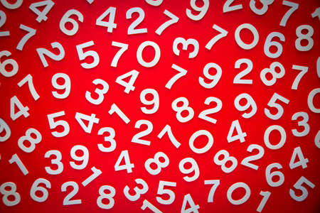 Mathematics background made with solid numbers on a board. Top view, isolated on redの写真素材