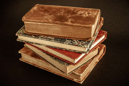 Stack of old books isolated on black background