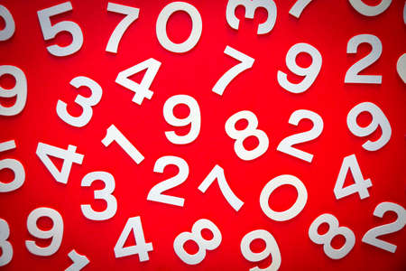 Mathematics background made with solid numbers on a board. Top view, isolated on redの写真素材