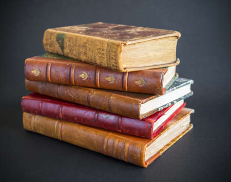 Stack of old books isolated on black backgroundの写真素材