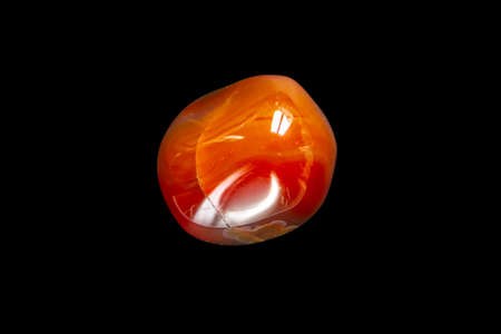Carnelian agate gemstone isolated on a black background