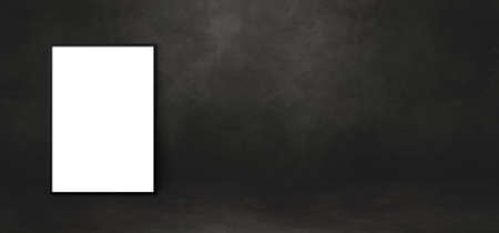 Blank picture frame leaning on a black wall. Presentation mockup template. Horizontal bannerの写真素材