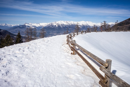 Mountain landscape under snow in winter and frozen lakeの写真素材