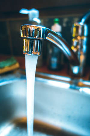Water tap, faucet, closeup view in a kitchenの写真素材