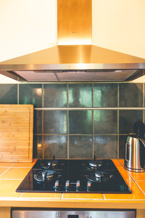 Extractor hood and gas stove in a kitchenの写真素材