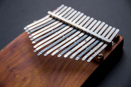 Traditional wooden kalimba isolated on black background