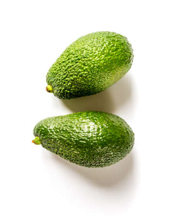 Two fresh avocados isolated on a white background