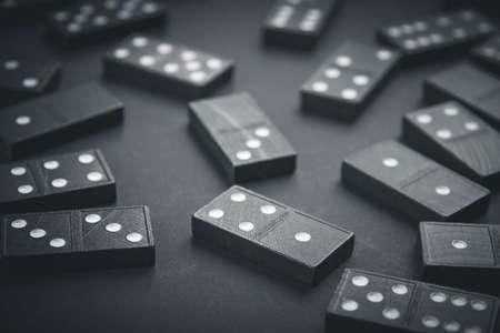 Black dominoes on a dark table backgroundの写真素材