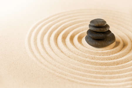 Black stones pile in the sand. Zen japanese garden background sceneの写真素材