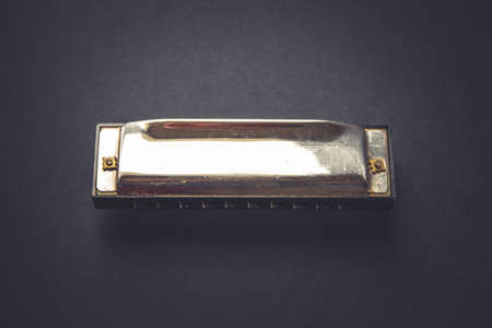 Vintage harmonica isolated on a black background