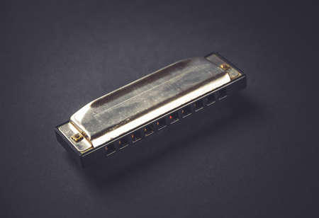 Vintage harmonica isolated on a black background