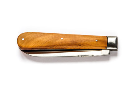 Traditional wooden pocket knife isolated on a white background
