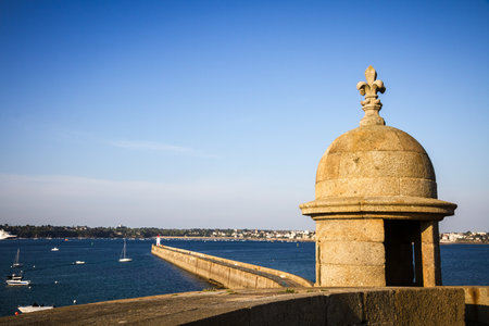 Saint-Malo lighthouse, sea and pier view from the city fortifications, Brittany, Franceの素材 [FY310186815920]