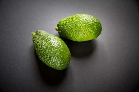 Two fresh avocados isolated on a black backgroundの写真素材