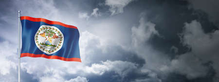 Belize flag on a cloudy sky, three dimensional renderの写真素材