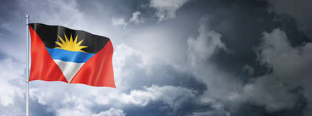 Antigua and Barbuda flag on a cloudy sky, three dimensional renderの写真素材