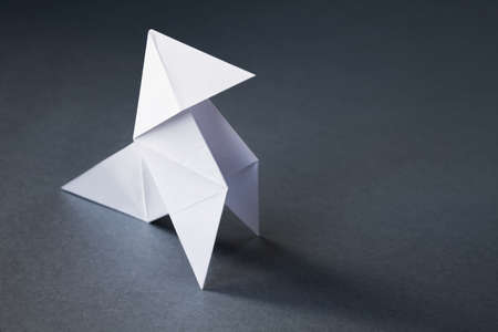 White paper hen origami isolated on a blank grey background. Cocotte en papierの素材 [FY310189207295]