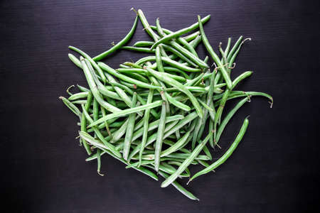 Fresh green beans isolated on black background