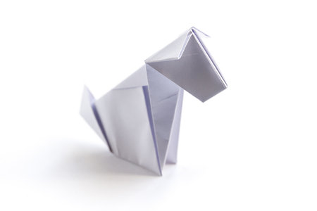 Paper dog origami isolated on a blank white background.の写真素材