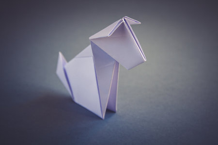 White paper dog origami isolated on a blank grey background.の写真素材