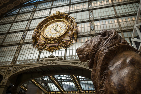 Paris - France - August 2, 2022 : Clock and lion statue in Orsay museum