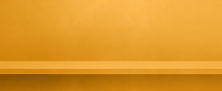 Empty shelf on a yellow gold concrete wall. Background template scene. Horizontal banner mockupの写真素材