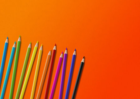 Wooden colored pencil set isolated on orange. Horizontal background.の写真素材