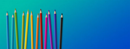 Wooden colored pencil set isolated on blue. Panoramic banner background.の写真素材