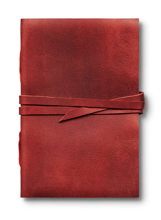 Old worn red leather notebook isolated on white background, closed with a bandの写真素材