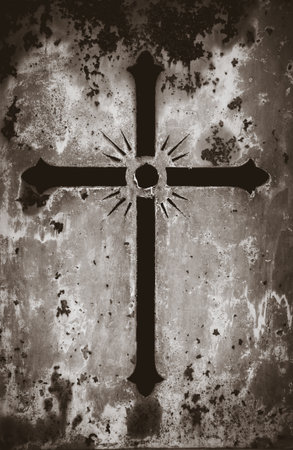 Crucifix on a rusty metal door - background texture. Black and white photoの写真素材