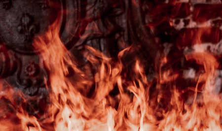 Flames in fireplace. Texture background isolated on a black background