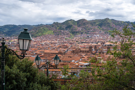 The city of Cusco, Peru, unfolds with terracotta rooftops, colonial architecture, and historic...