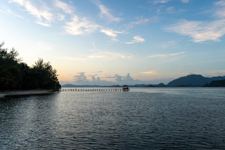 A peaceful sunset over the long wooden pier on Bolilanga Island, Togian archipelago, Sulawesi,...