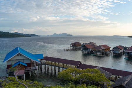 Traditional fishermen houses built on stilts over calm waters in the Bajo village of Pulau Papan on...